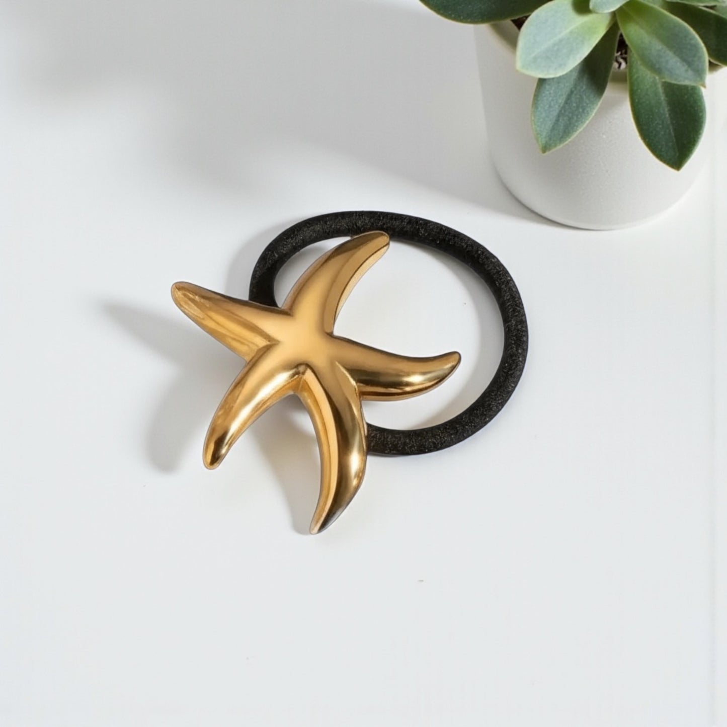 Golden Starfish Hair Tie - polished gold starfish on black elastic