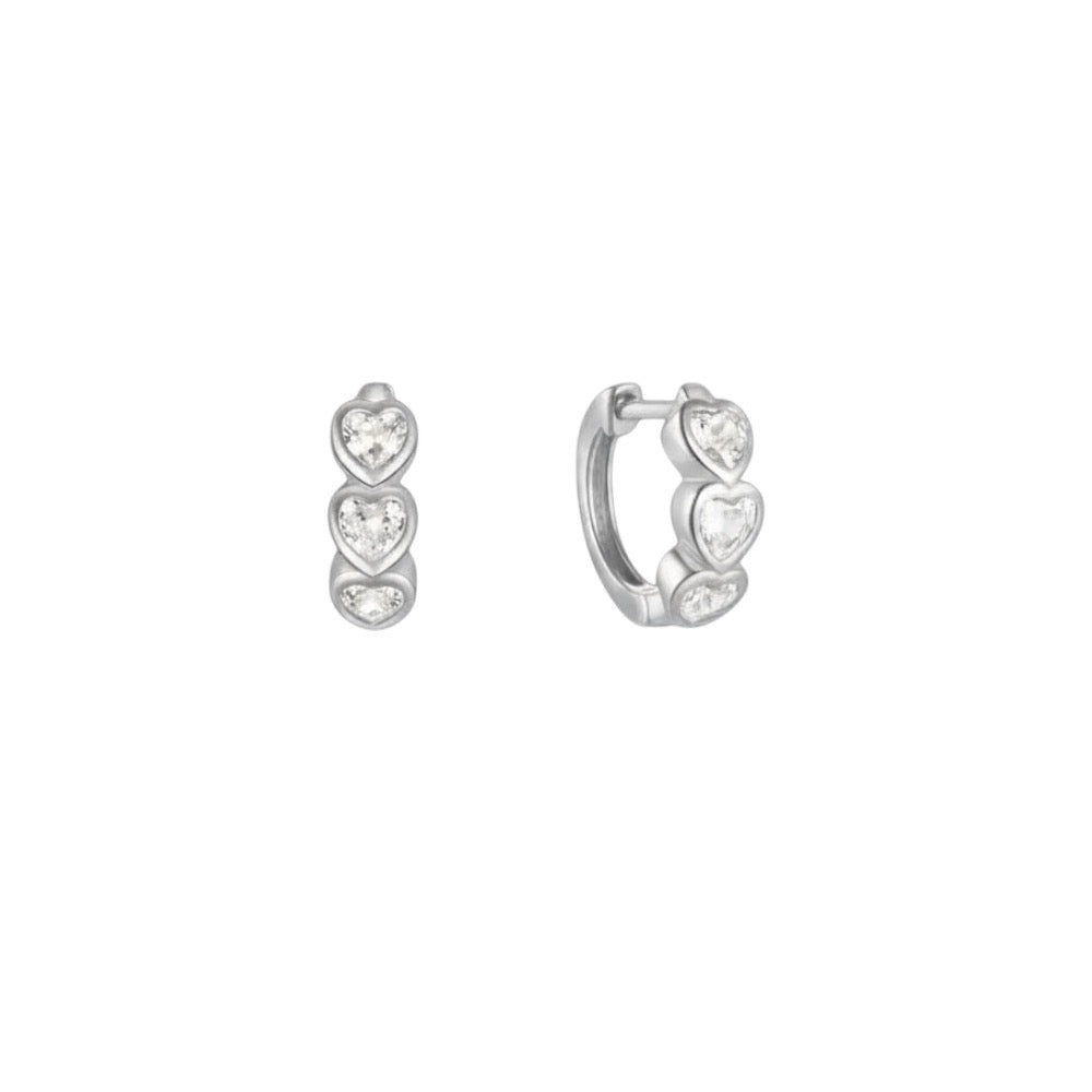 Heart Huggie Hoop Earrings in sterling silver with white gold plating, featuring three sparkling heart-shaped stones