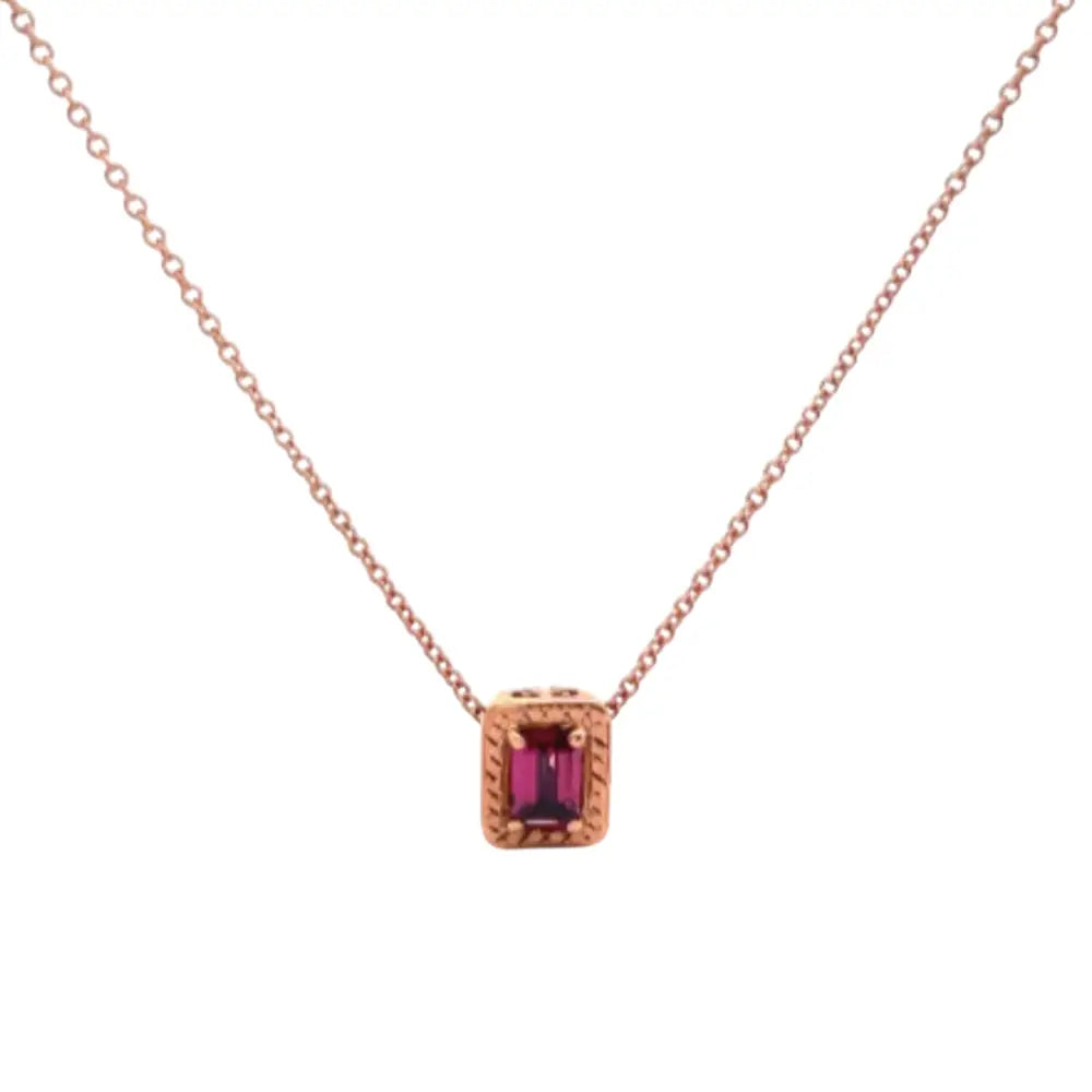 Rose gold necklace with a red gemstone pendant on a white background