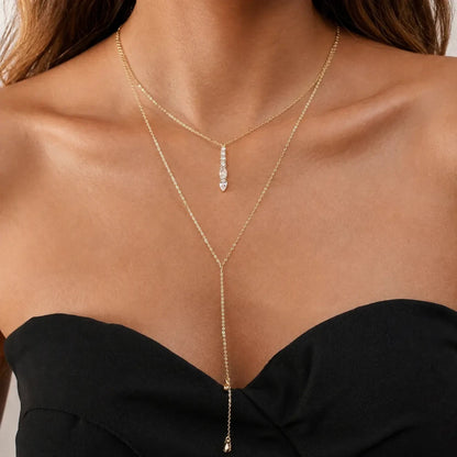 Scandal Kiss Cascading Drop Y Necklace styled on the neck with an elongated drop silhouette