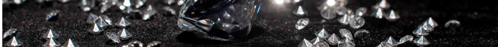A collection of clear, reflective, faceted gemstones.