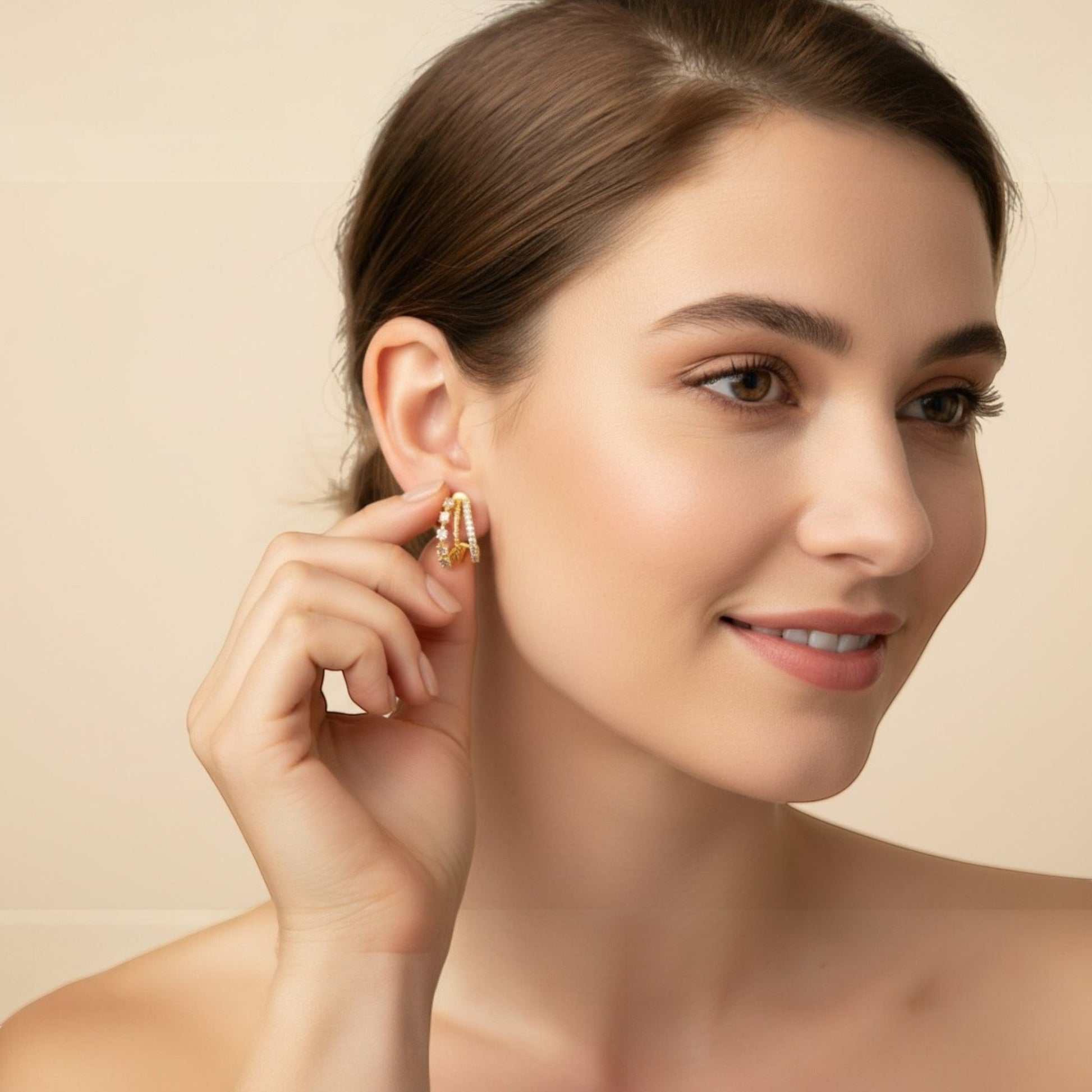 Gold curve stud earrings in sterling silver with layered pavé and zirconia detailing