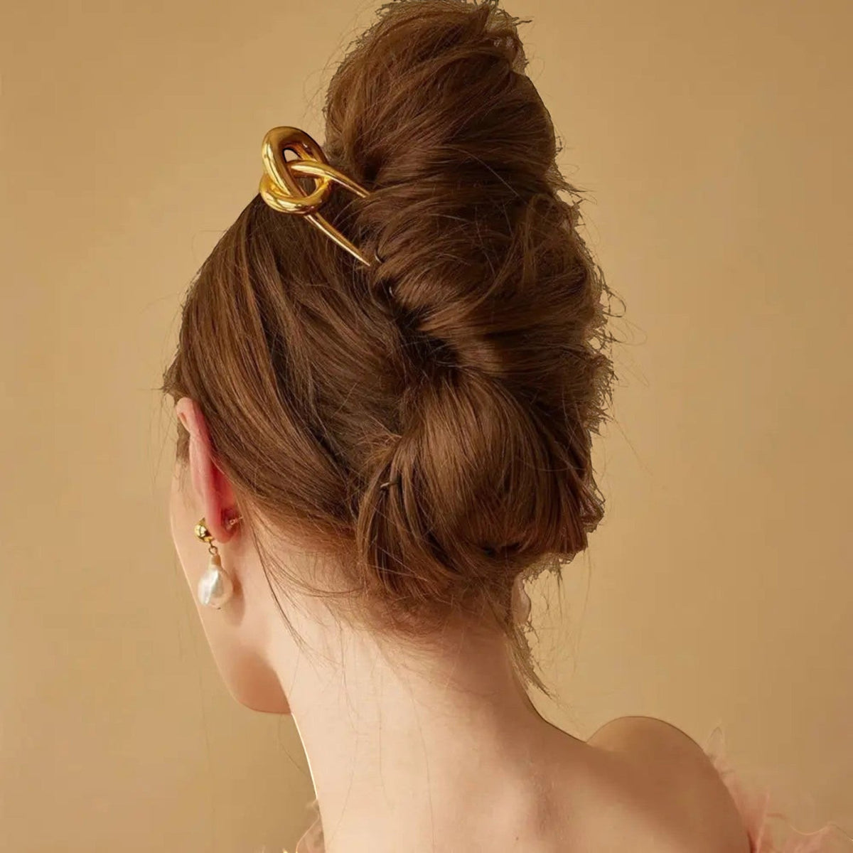 Gold Knot Hair Pin styled in a twisted bun hairstyle