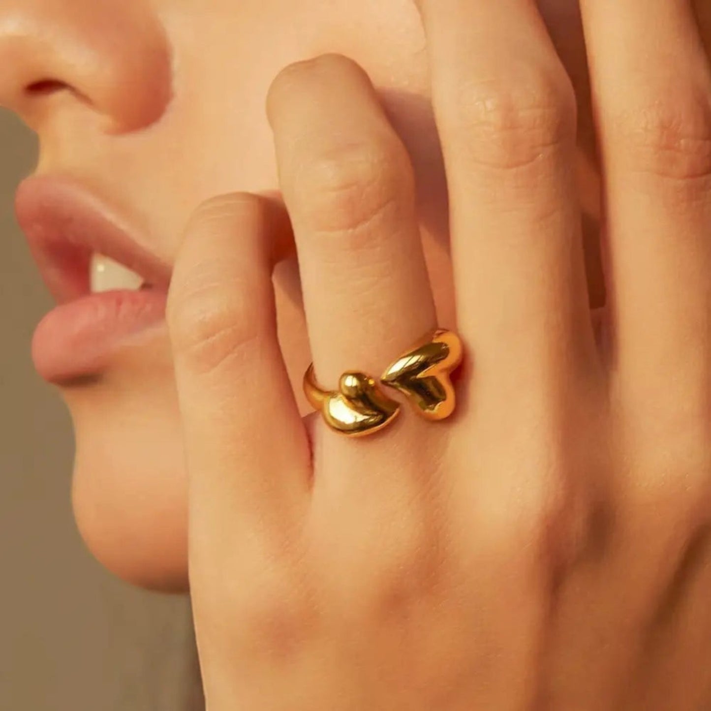 Gold Heart Wrap Ring with two sculpted hearts in an open wraparound design