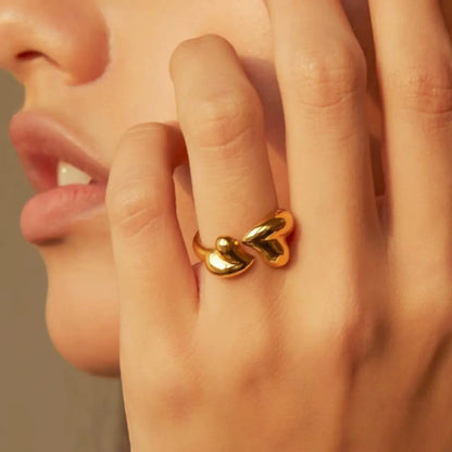 Gold Heart Wrap Ring with two sculpted hearts in an open wraparound design