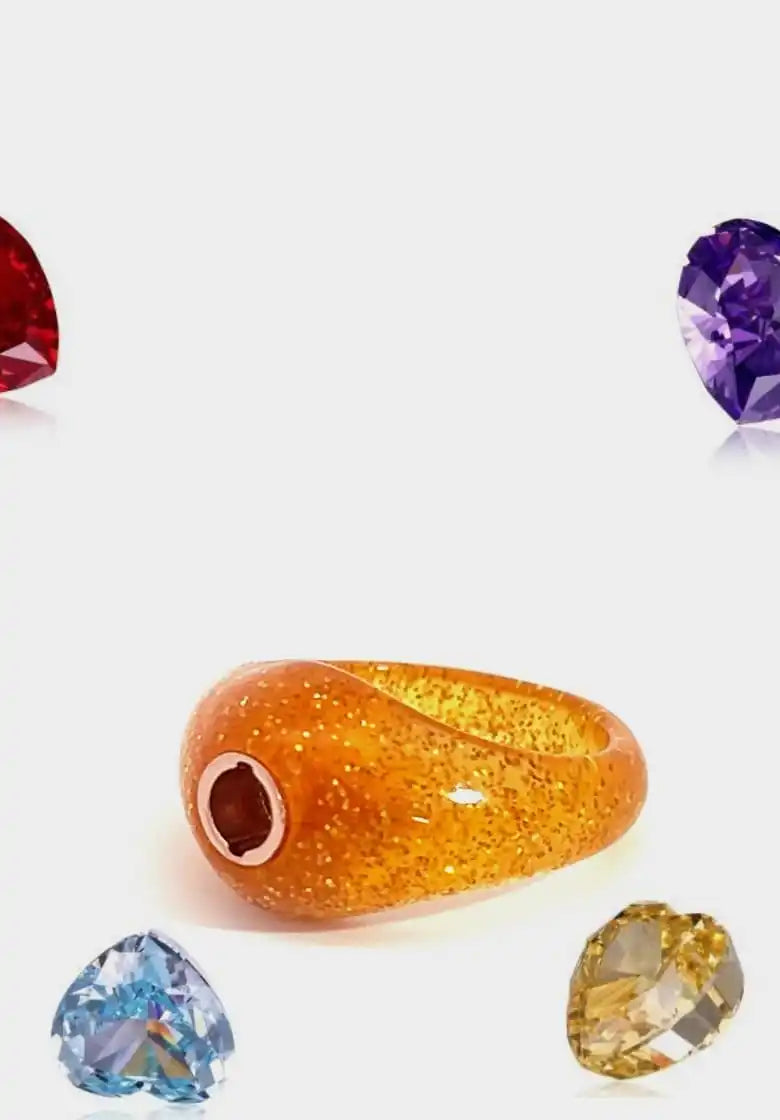 Glittering orange resin ring with a rose gold accent.
