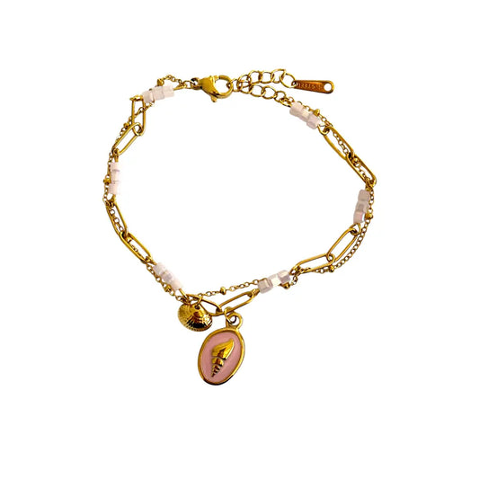 The Pink Cameo Link Bracelet is an elegant blend of vintage romance and seaside charm