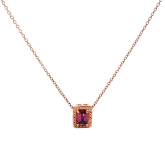 Rose gold necklace with a red gemstone pendant on a white background