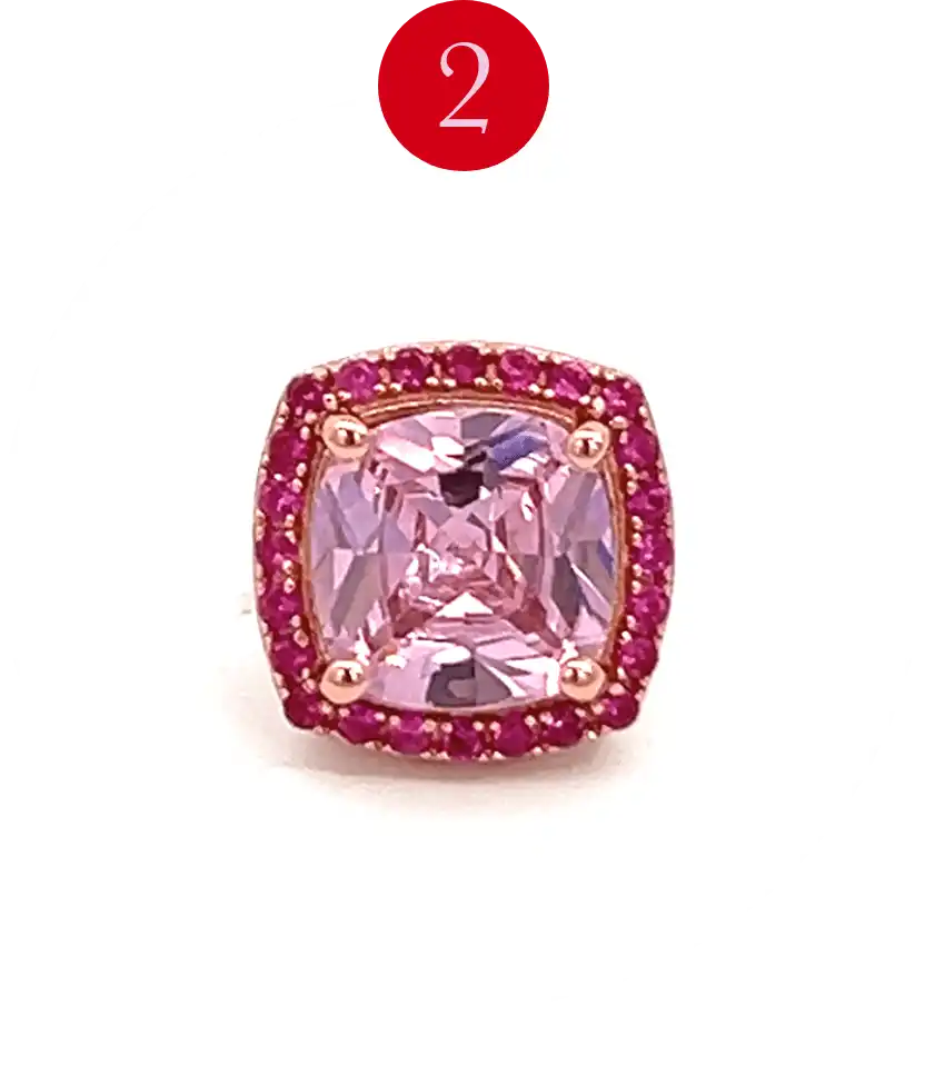 Rose gold ring with a cushion-cut pink gemstone surrounded by a halo of smaller pink stones.
