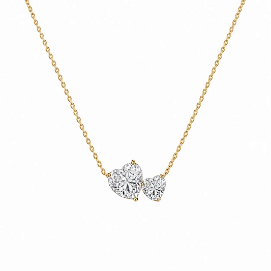 Scandal Kiss double heart necklace featuring two asymmetrical zirconia stones on an 18ct gold-plated silver chain.