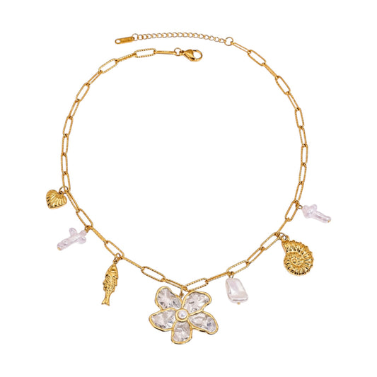 Scandal Kiss gold flower charm necklace featuring a statement floral pendant, mixed charms, and organic stone drops.