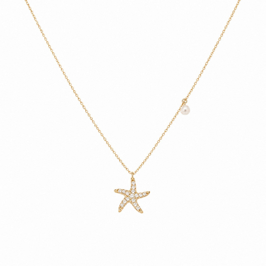 Scandal Kiss gold plated sterling silver starfish necklace with zirconia stones and a delicate faux pearl accent.