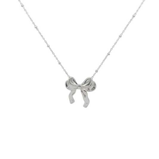 Scandal Kiss rhodium-plated stainless steel bow necklace featuring a delicate beaded chain on a white background.