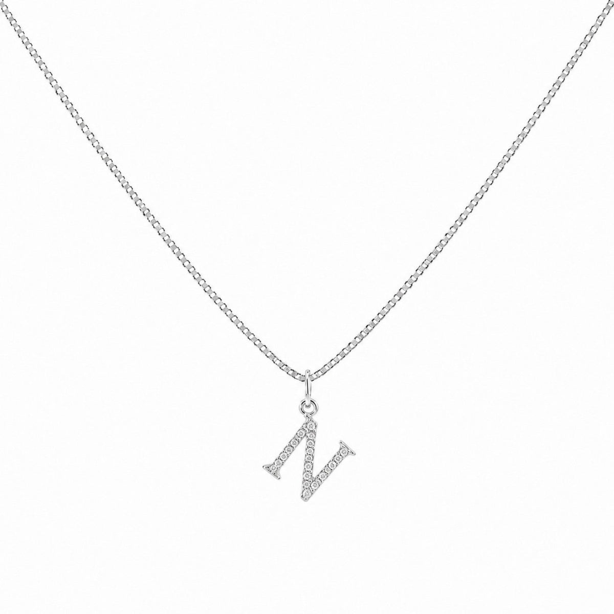 Scandal Kiss sterling silver initial charm with sparkling zirconia stones on a delicate silver chain