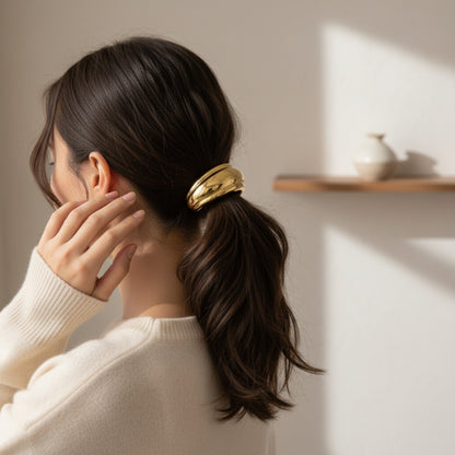 Gold Sculpted Cuff Hair Tie with a smooth polished curved cuff and black elastic