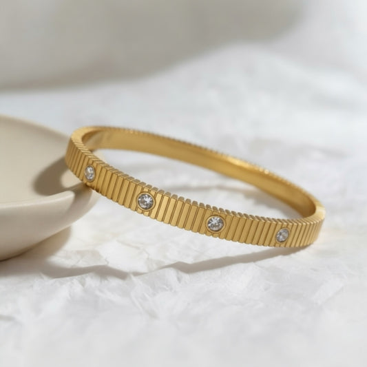 Textured Zirconia Bangle in gold plated stainless steel with evenly spaced zirconia stones and 6cm diameter