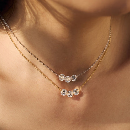 Gold and rhodium Triple Stone Necklaces featuring three round zirconia stones in 925 sterling silver