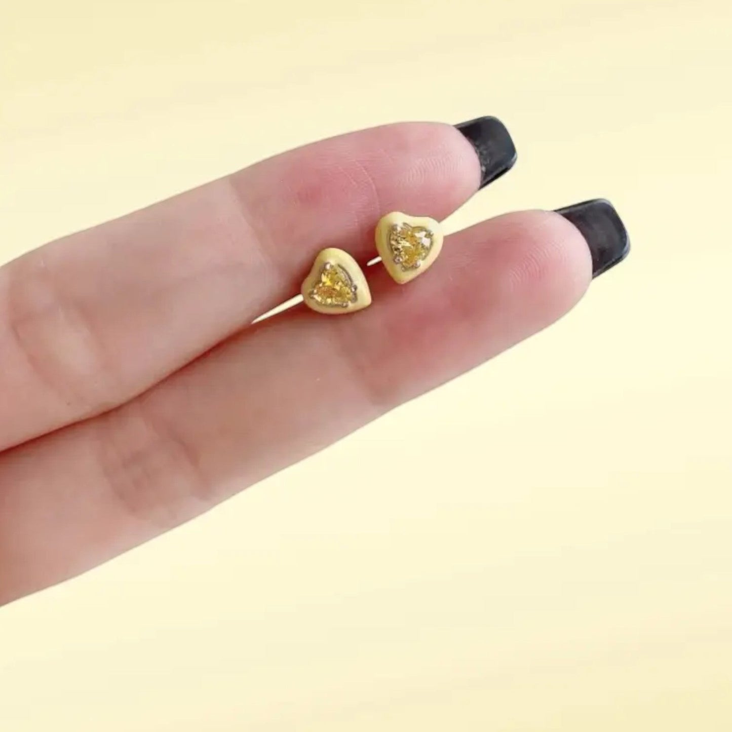 Yellow enamel heart stud earrings in gold plated sterling silver with a glossy finish