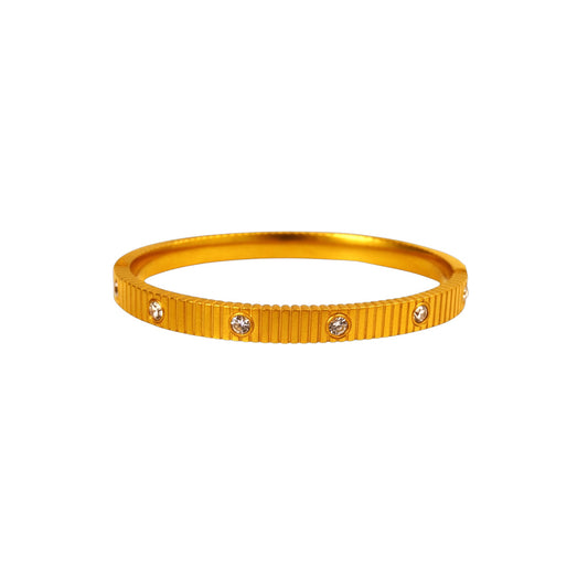 Textured zirconia bangle in gold plated stainless steel with stone accents